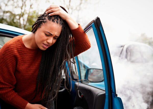 Female,Motorist,With,Head,Injury,Getting,Out,Of,Car,After
