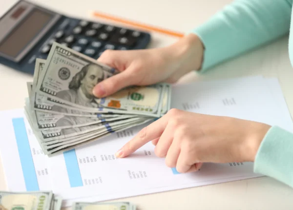 Woman calculating child support, is child support based on income or net worth?
