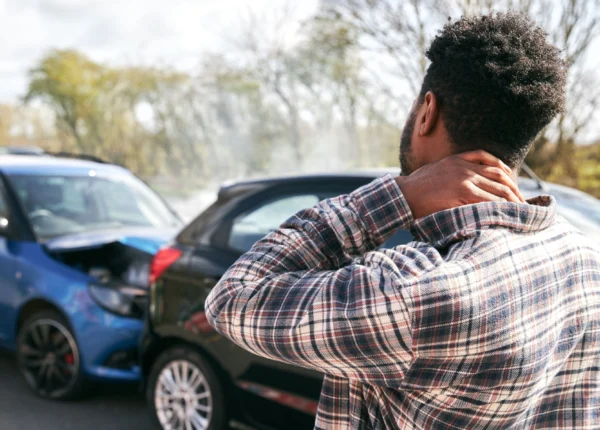 Man holding his injured neck after a car accident in Houston