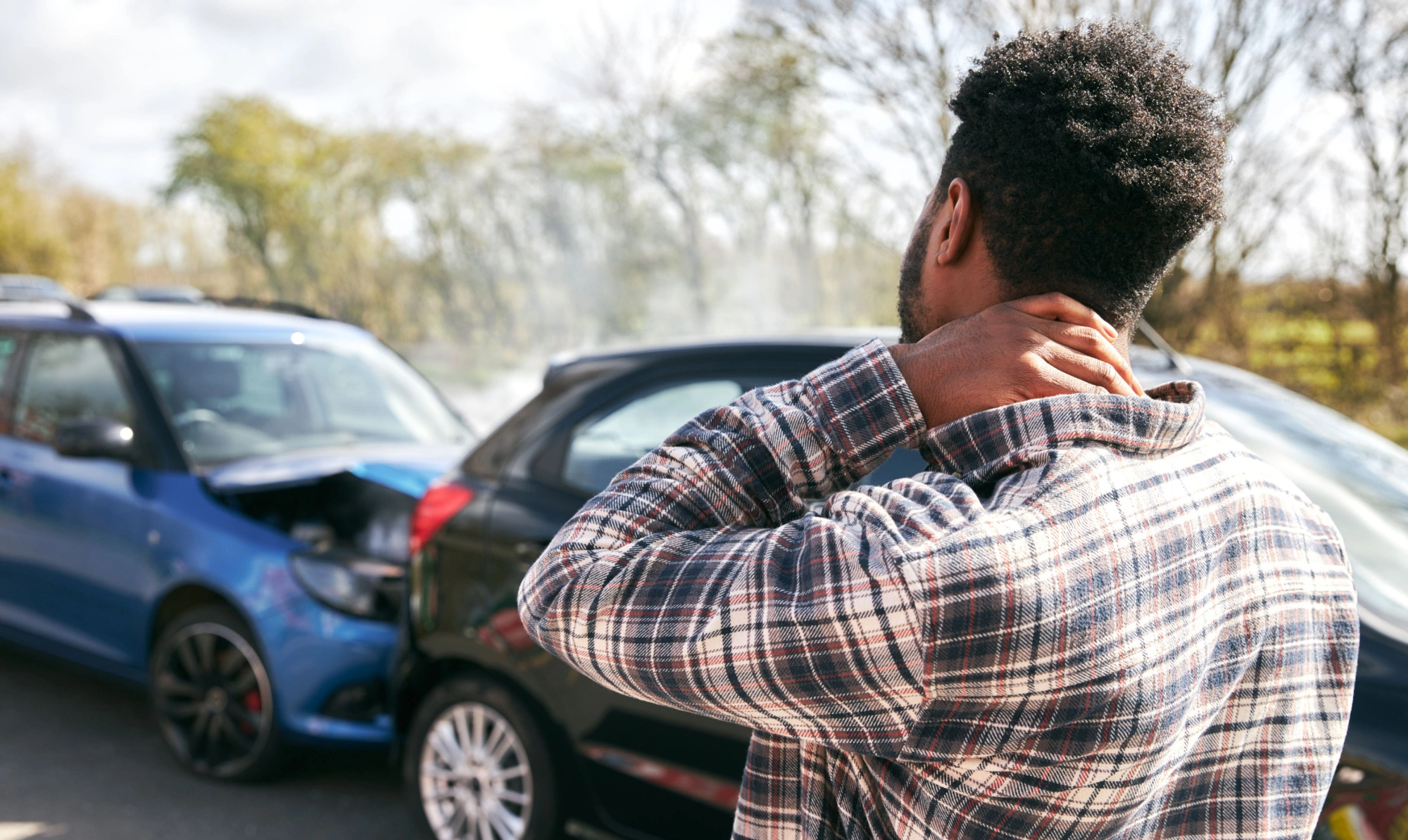 Man holding his injured neck after a car accident in Houston