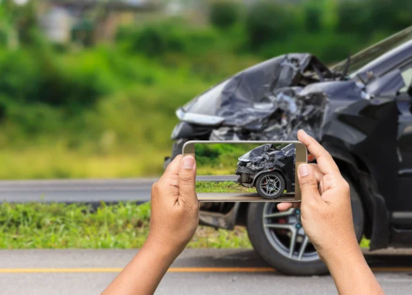 Woman taking picture of evidence for a drunk driver lawsuit