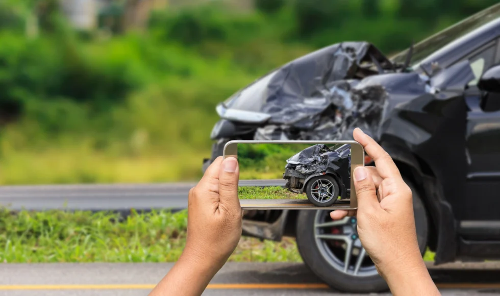 Woman taking picture of evidence for a drunk driver lawsuit