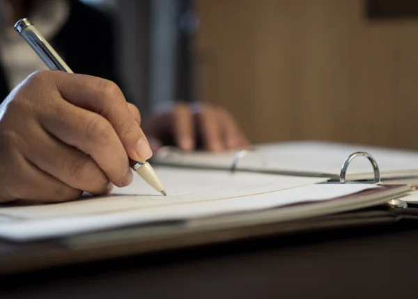 Lawyer taking notes in a binder