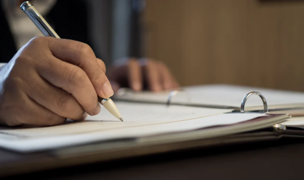 Lawyer taking notes in a binder