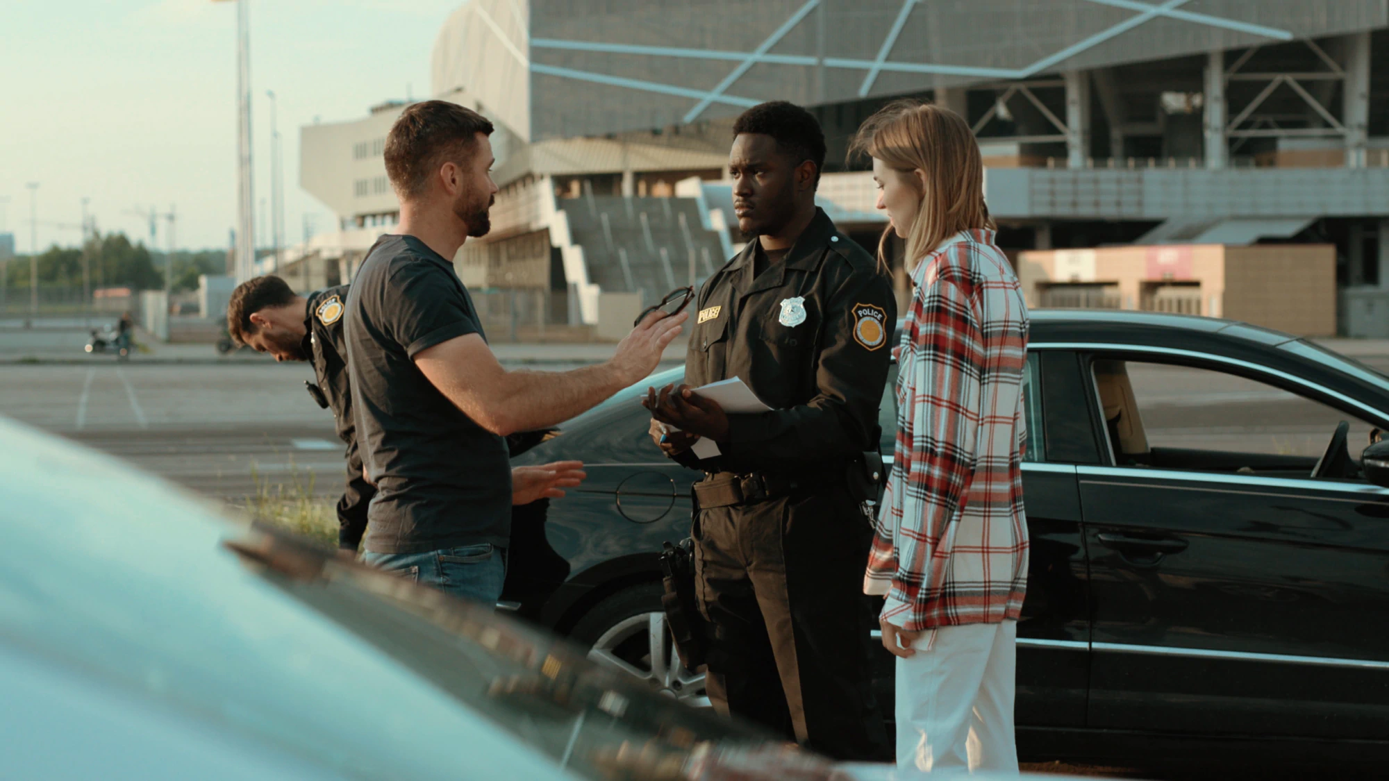 Couple talking to police officer at the scene of an accident.