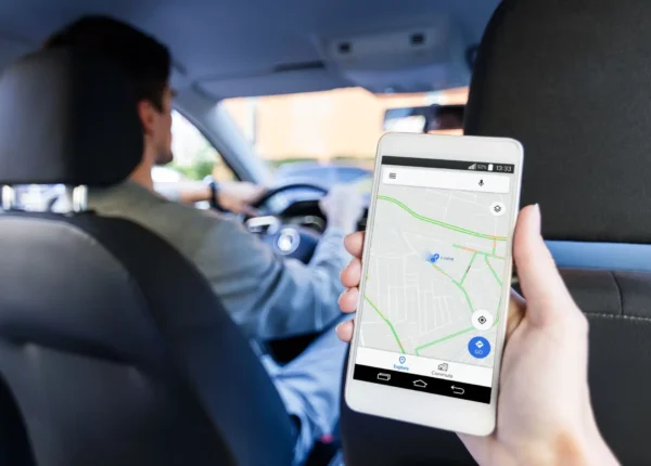 Backseat view of a rideshare driver and a map
