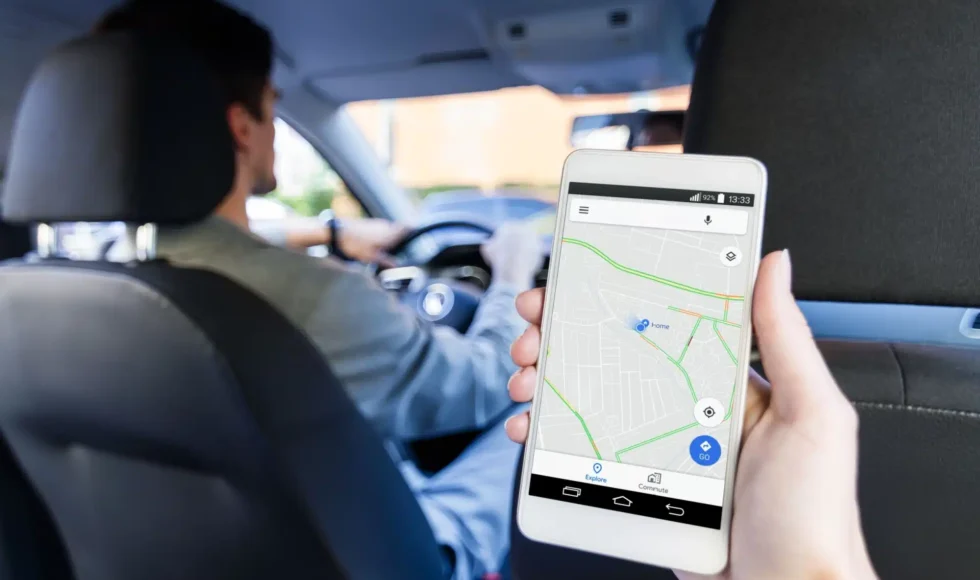 Backseat view of a rideshare driver and a map