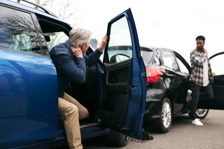 Two drivers getting out of their car after a car crash