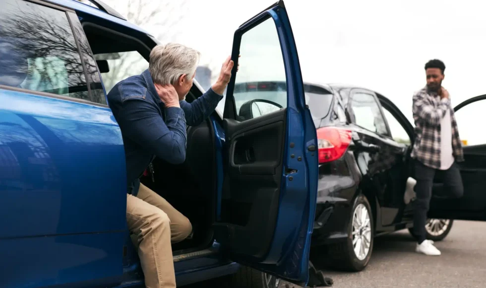 Two drivers getting out of their car after a car crash