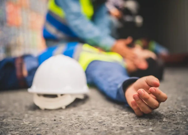 Construction worker lying on the ground with an injury
