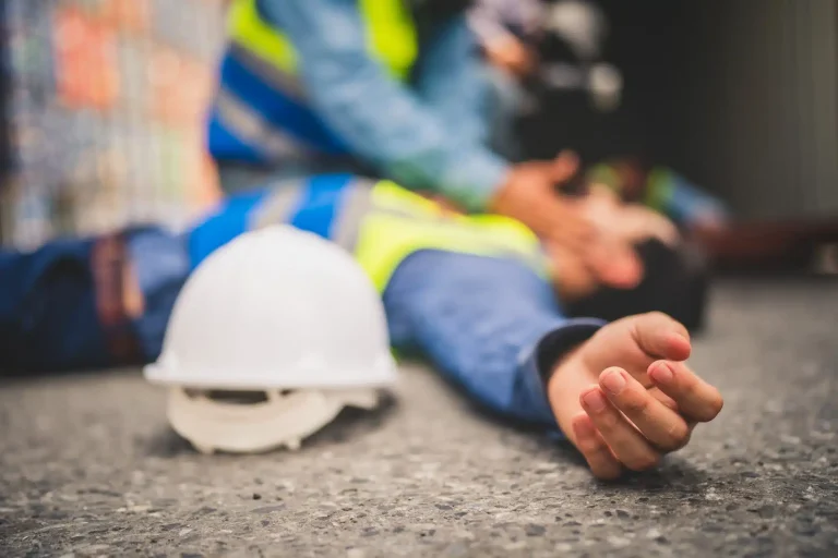 Construction worker lying on the ground with an injury